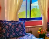 تخت خواب باروتختی آبی و پنجره رو به محوطه اتاق خواب آپارتمان در نمک آبرود